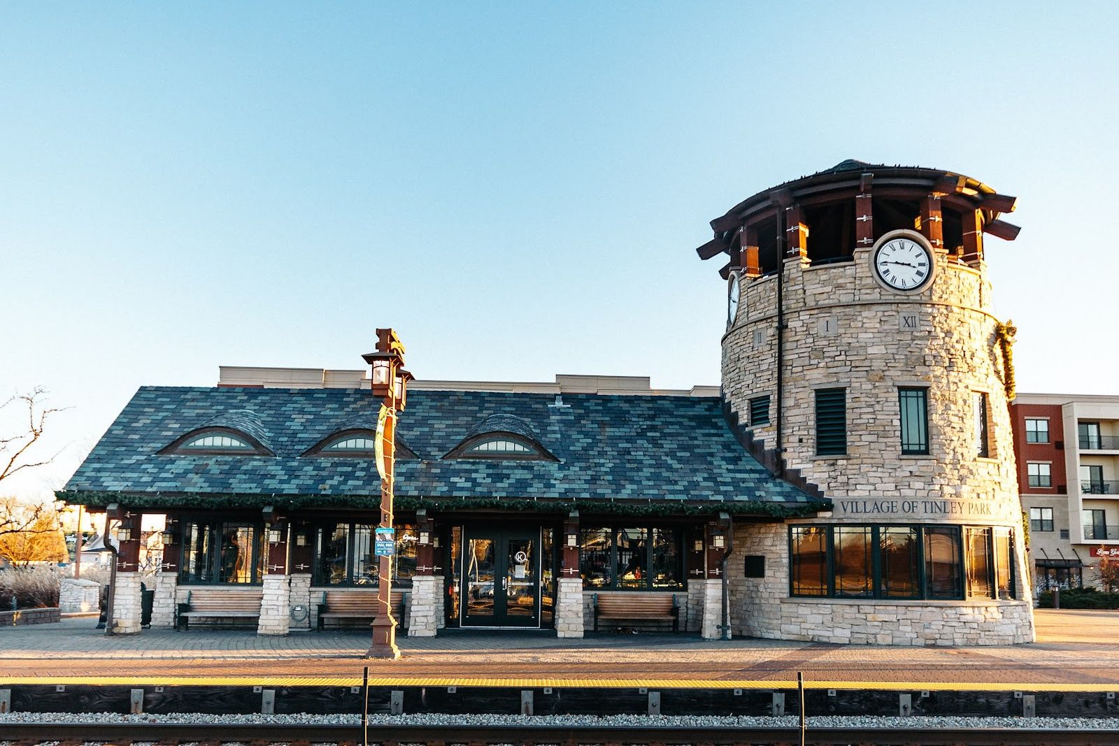 Krema Coffee Roasters building with its stone clock tower in Tinley Park